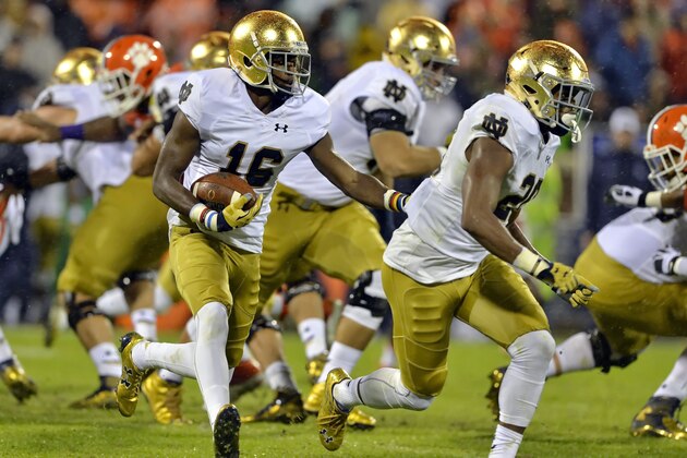 FILE - In this Oct. 3, 2015, file photo, Notre Dame's Torii Hunter Jr. (16) with blocking help from C. J. Prosise, rushes out of the backfield during the first half of an NCAA college football game against Clemson  in Clemson,  S.C.  The Los Angeles Angels enlisted their former All-Star outfielder Torii Hunter to announce during the draft conference call that they had selected Torii Hunter Jr., an athletic outfielder for Notre Dame, in the 23rd round of baseball's draft Satuday, June 11, 2016. (AP Photo/Richard Shiro, File)
