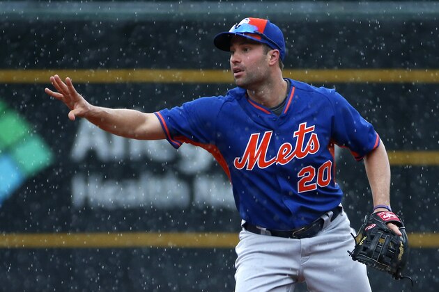 New York Mets second baseman Neil Walker takes ground balls in the rain before a baseball game against his hometown team the Pittsburgh Pirates in Pittsburgh, Monday, June 6, 2016. The game was postponed due to rain. (AP Photo/Gene J. Puskar)