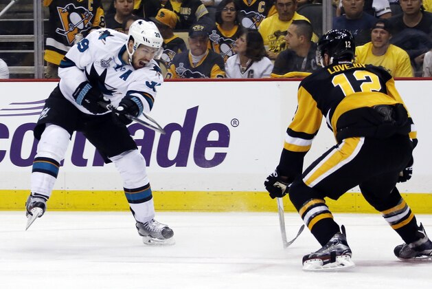 San Jose Sharks' Logan Couture, left, fires the puck past Pittsburgh Penguins' Ben Lovejoy during the second period in Game 5 of the NHL hockey Stanley Cup Finals on Thursday, June 9, 2016, in Pittsburgh. (AP Photo/Keith Srakocic)