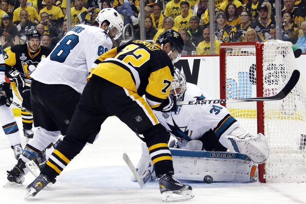 San Jose Sharks goalie Martin Jones (31) turns a shot away as Pittsburgh Penguins' Patric Hornqvist (72) and Sharks' Brent Burns (88) scramble in front of the net during the third period in Game 5 of the NHL hockey Stanley Cup Finals on Thursday, June 9, 2016, in Pittsburgh. (AP Photo/Keith Srakocic)