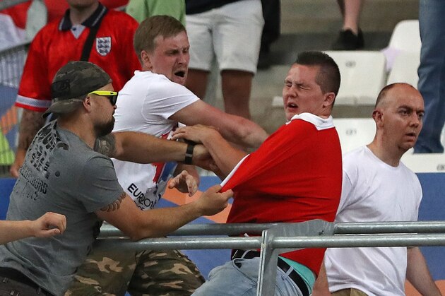 Russian supporters attack an England fan at the end of the Euro 2016 Group B soccer match between England and Russia, at the Velodrome stadium in Marseille, France, Saturday, June 11, 2016.  (AP Photo/Thanassis Stavrakis)