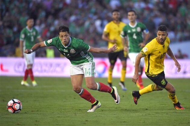 Mexico forward Chicharito, left, moves the ball as Jamaica midfielder Joel McAnuff pressures him during a Copa America group C soccer match at the Rose Bowl, Thursday, June 9, 2016, in Pasadena, Calif. (AP Photo/Mark J. Terrill)
