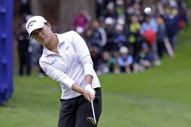 Lydia Ko, of New Zealand, chips onto the 17th green in the third round at the Women's PGA Championship golf tournament at Sahalee Country Club, Saturday, June 11, 2016, in Sammamish, Wash. (AP Photo/Elaine Thompson)