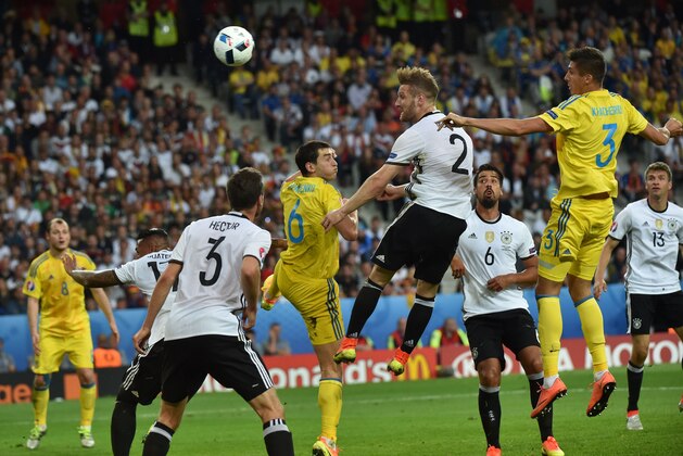 Germany's defender Shkodran Mustafi (2nd-R) jumps to head the ball between Ukraine's midfielder Taras Stepanenko (C) and Ukraine's defender Yevhen Khacheridi (R) during the Euro 2016 group C football match between Germany and Ukraine at the Stade Pierre Mauroy in Villeneuve-d'Ascq near Lille on June 12, 2016. / AFP / PHILIPPE HUGUEN        (Photo credit should read PHILIPPE HUGUEN/AFP/Getty Images)