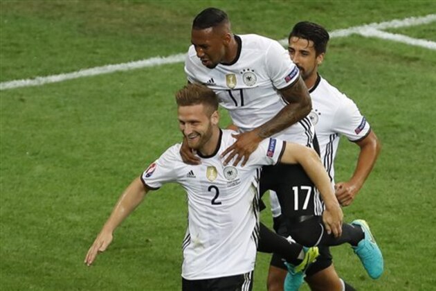 Germany's Shkodran Mustafi, left, celebrates with his teammates Jerome Boateng and Sami Khedira after scoring the opening goal  during the Euro 2016 Group C soccer match between Germany and Ukraine at the Pierre Mauroy stadium in Villeneuve d'Ascq, near Lille, France, Sunday, June 12, 2016. (AP Photo/Darko Vojinovic)