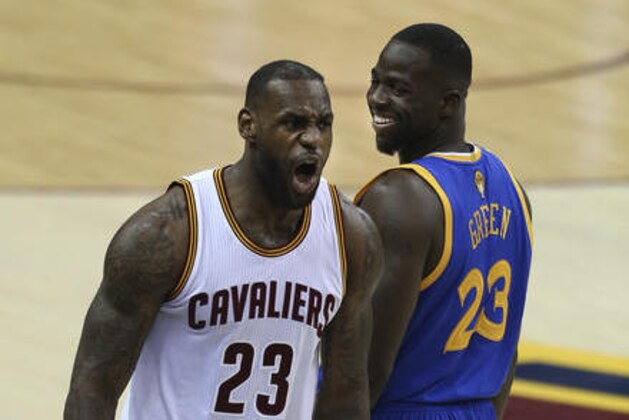 Cleveland Cavaliers forward LeBron James, left, reacts as Golden State Warriors forward Draymond Green, right, looks back during the first half of Game 3 of basketball's NBA Finals in Cleveland, Wednesday, June 8, 2016. (AP Photo/Ron Schwane)