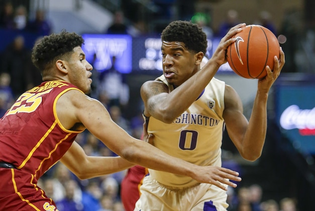 Jan 3, 2016; Seattle, WA, USA; Washington Huskies forward Marquese Chriss (0) holds the ball as USC Trojans forward Bennie Boatwright (25) defends during the first half at Alaska Airlines Arena. Mandatory Credit: Jennifer Buchanan-USA TODAY Sports