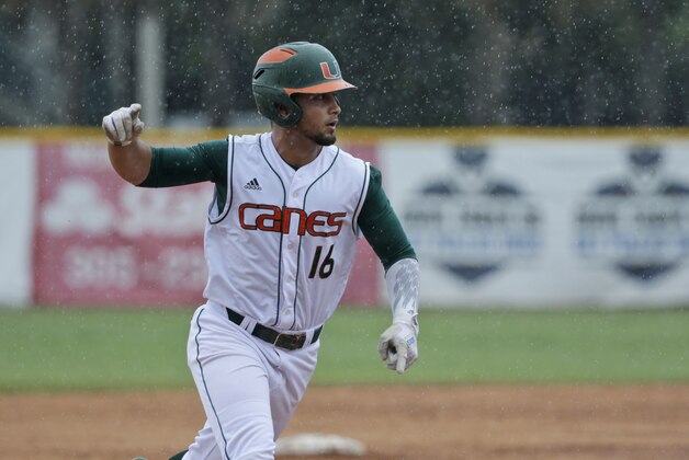 Miami's Edgar Michelangeli celebrates as he rounds third base after he hit a grand slam in the seventh inning of NCAA college baseball tournament super regional game against Boston College, Sunday, June 12, 2016, in Coral Gables, Fla. (AP Photo/Wilfredo Lee)