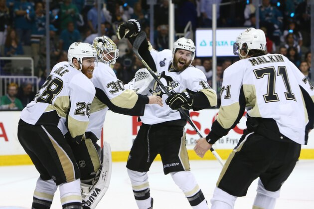 Jun 12, 2016; San Jose, CA, USA; Pittsburgh Penguins goalie Matt Murray (30) celebrates with defenseman Ben Lovejoy (12) and defenseman Ian Cole (28) and center Evgeni Malkin (71) after defeating the San Jose Sharks in game six of the 2016 Stanley Cup Final at SAP Center at San Jose. Mandatory Credit: Jerry Lai-USA TODAY Sports