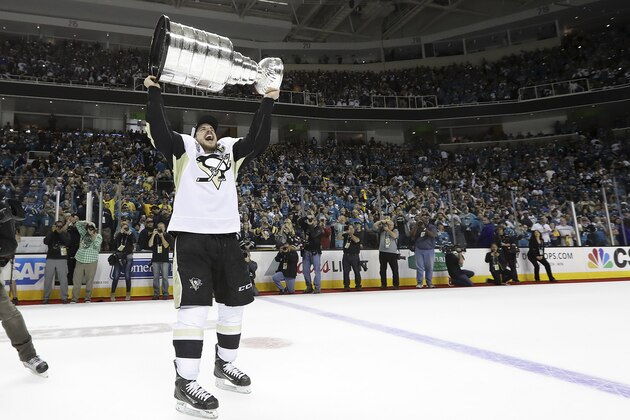 Pittsburgh Penguins center Sidney Crosby (87) raises the Stanley Cup after Game 6 of the NHL hockey Stanley Cup Finals between the San Jose Sharks and the Penguins in San Jose, Calif., Sunday, June 12, 2016. The Penguins won 3-1 to win the series 4-2. (Bruce Bennett/Getty Images via AP, Pool)