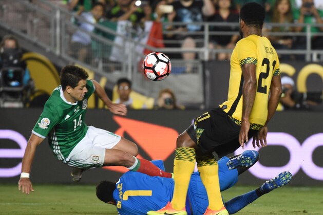 Mexico's Javier 'Chicharito' Hernandez (L) vies fr the ball with Jamaica's goalie Andre Blake and Jamaica's Jermaine Taylor during the Copa America Centenario football match in Pasadena, California, United States, on June 9, 2016.  / AFP / Mark Ralston        (Photo credit should read MARK RALSTON/AFP/Getty Images)