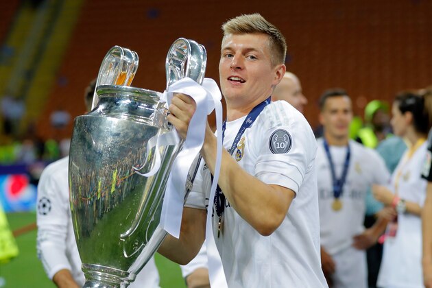 Real Madrid's Toni Kroos celebrates with the trophy after the Champions League final soccer match between Real Madrid and Atletico Madrid at the San Siro stadium in Milan, Italy, Saturday, May 28, 2016. Real Madrid won 5-3 on penalties after the match ended 1-1 after extra time.     (AP Photo/Manu Fernandez)