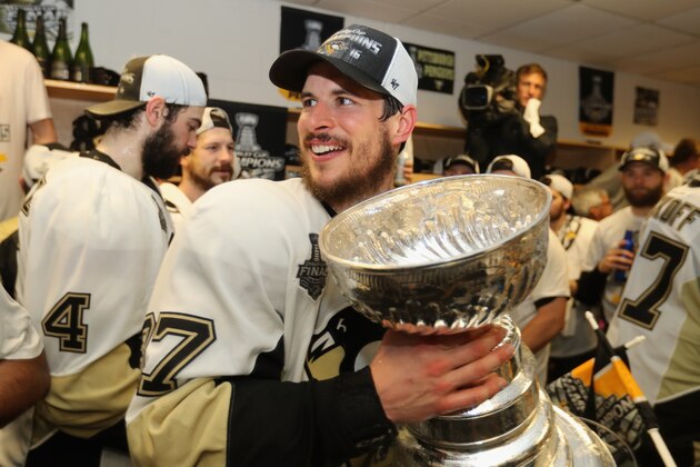 SAN JOSE, CA - JUNE 12:  Sidney Crosby #87 of the Pittsburgh Penguins celebrates with the Stanley Cup in the locker room after winning Game 6 of the 2016 NHL Stanley Cup Final over the San Jose Sharks at SAP Center on June 12, 2016 in San Jose, California. The Penguins won the game 3-1 and the series 4-2.  (Photo by Dave Sandford - Pool/Getty Images)