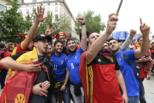 Belgium and Italy supporters take a selfie in a street of Lyon before the Euro 2016 group E football match between Belgium and Italy during the Euro 2016 football tournament on June 13, 2016. / AFP / PHILIPPE DESMAZES        (Photo credit should read PHILIPPE DESMAZES/AFP/Getty Images)