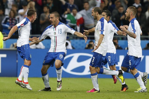 Italy's Emanuele Giaccherini, left, celebrates with teammates after scoring his side's first goal during the Euro 2016 Group E soccer match between Belgium and Italy at the Grand Stade in Decines-Charpieu, near Lyon, France, Monday, June 13, 2016. (AP Photo/Antonio Calanni)