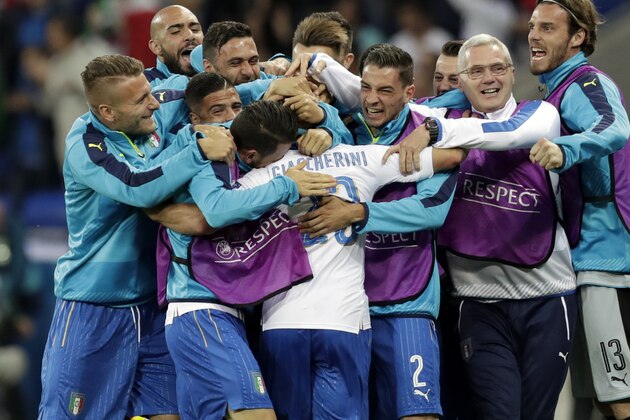 Italy's Emanuele Giaccherini, center, celebrates after scoring the opening goal during the Euro 2016 Group E soccer match between Belgium and Italy at the Grand Stade in Decines-Charpieu, near Lyon, France, Monday, June 13, 2016. (AP Photo/Pavel Golovkin)