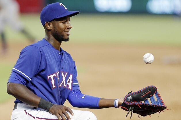 Texas Rangers first baseman Jurickson Profar (19) tosses a ball into the air during a baseball game against the Houston Astros, Tuesday, June 7, 2016, in Arlington, Texas. Texas won 4-3. (AP Photo/Brandon Wade)