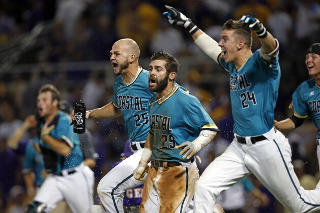 Coastal Carolina's Anthony Marks (29) reacts after sliding into home plate to score the winning run in the bottom of the ninth inning of an NCAA college baseball tournament super regional game against LSU in Baton Rouge, La., Sunday, June 12, 2016. Coastal Carolina won 4-3 to advance to the College World Series. (AP Photo/Gerald Herbert)