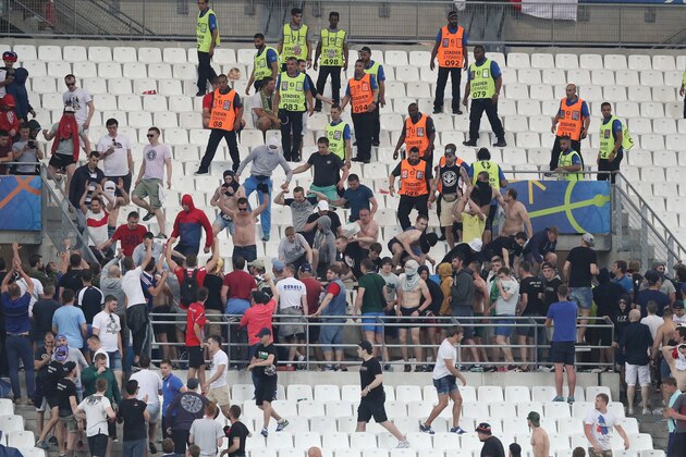 Stewards watch Russian supporters in the stands at the end of the Euro 2016 Group B soccer match between England and Russia, at the Velodrome stadium, in Marseille, France, Saturday, June 11, 2016. (AP Photo/Claude Paris)