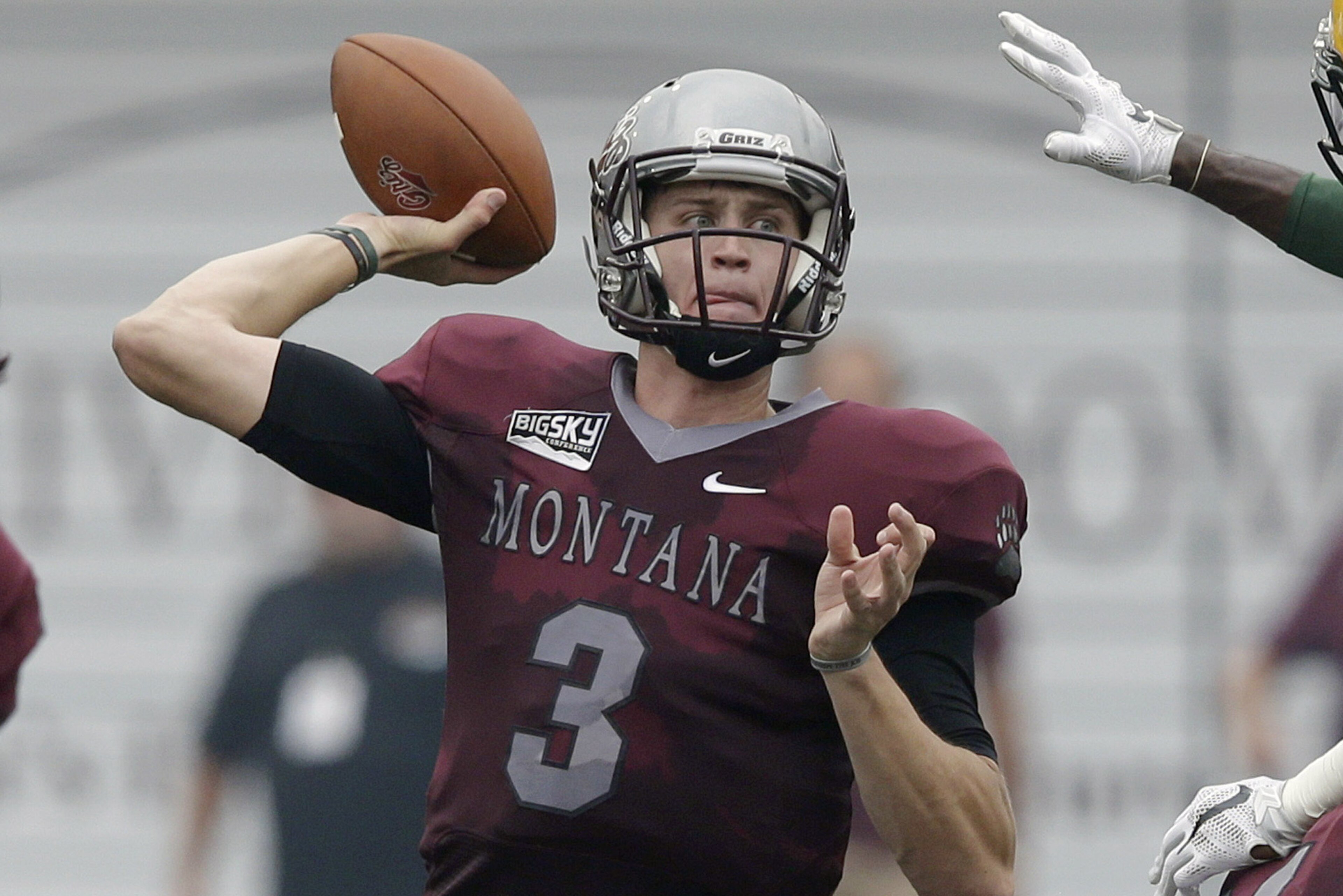 Montana's quarterback Brady Gustafson (3) passes the ball as North Dakota State's Tre Dempsey (3) defends during the first half of an NCAA college football game Saturday, Aug. 29, 2015, in Missoula, Mont.  (AP Photo/Rick Bowmer)