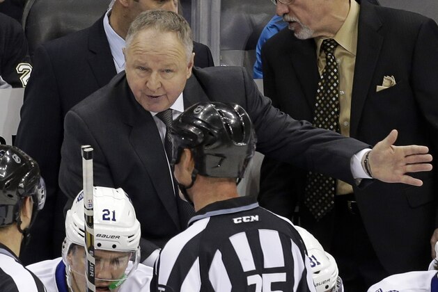 Toronto Maple Leafs head coach Randy Carlyle talks with linesman Derek Amell (75) before a shootout in an NHL hockey game against the Pittsburgh Penguins in Pittsburgh Wednesday, Nov. 27, 2013. The Penguins won 6-5 in a shootout. (AP Photo/Gene J. Puskar)