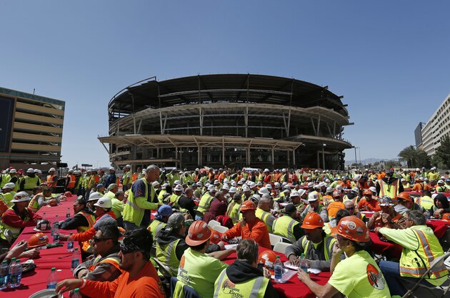 FILE - In this April 7, 2015, file photo, construction workers eat lunch by an MGM arena being built behind the New York-New York casino-hotel in Las Vegas. A person with direct knowledge of the NHL's decision says the league has settled on Las Vegas as its choice for expansion, provided organizers can come up with a $500 million fee. The person spoke Tuesday, June 14, 2016,  on condition of anonymity because details have not been released by the league ahead of its Board of Governors meeting on June 22. (AP Photo/John Locher, FIle)