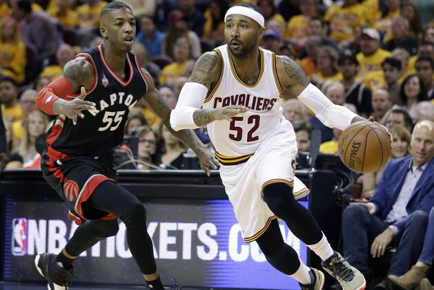 Cleveland Cavaliers' Mo Williams (52) drives around Toronto Raptors' Delon Wright (55) during the second half of Game 1 of the NBA basketball Eastern Conference finals, Tuesday, May 17, 2016, in Cleveland. (AP Photo/Tony Dejak)