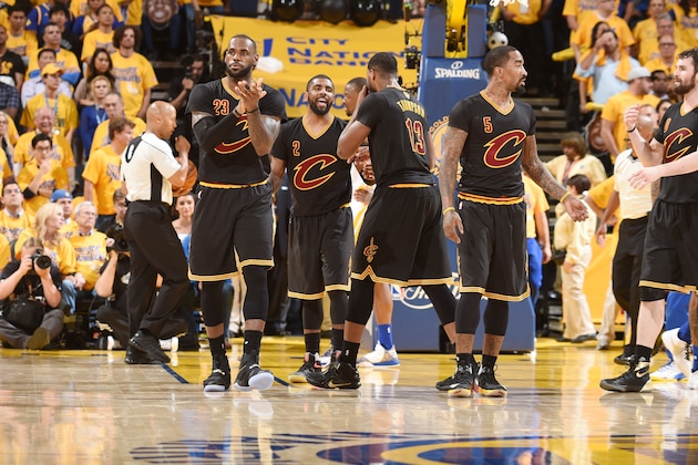 OAKLAND, CA - JUNE 13:  LeBron James #23 of the Cleveland Cavaliers and Kyrie Irving #2 of the Cleveland Cavaliers celebrate with their teammates during the game against the Golden State Warriors in Game Five of the 2016 NBA Finals on June 13, 2016 at ORACLE Arena in Oakland, California. NOTE TO USER: User expressly acknowledges and agrees that, by downloading and/or using this Photograph, user is consenting to the terms and conditions of the Getty Images License Agreement. Mandatory Copyright Notice: Copyright 2016 NBAE (Photo by Andrew D. Bernstein/NBAE via Getty Images)