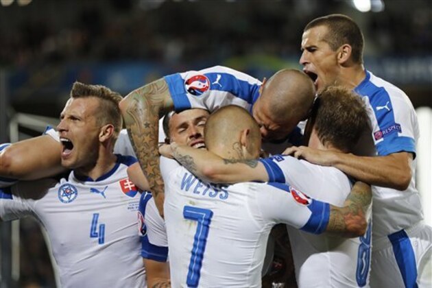 Slovakia's players celebrate after Marek Hamsik, second from left, scored his side's second goal during the Euro 2016 Group B soccer match between Russia and Slovakia at the Pierre Mauroy stadium in Villeneuve d’Ascq, near Lille, France, Wednesday, June 15, 2016. (AP Photo/Frank Augstein)