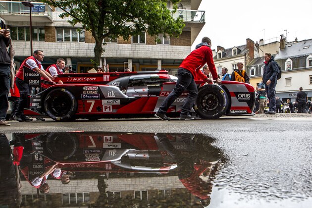 LE MANS, FRANCE - JUNE 13:  Crewmen push the #7 Audi R18 of  Marcel Fassler, of Switzland, Andre Lotterer, of Belgium,  and Benoit Treluyer, of France,  during scrutineering for the Le Mans 24 Hour Race on June 13, 2016 in Le Mans, France.  (Photo by Brian Cleary/Getty Images)