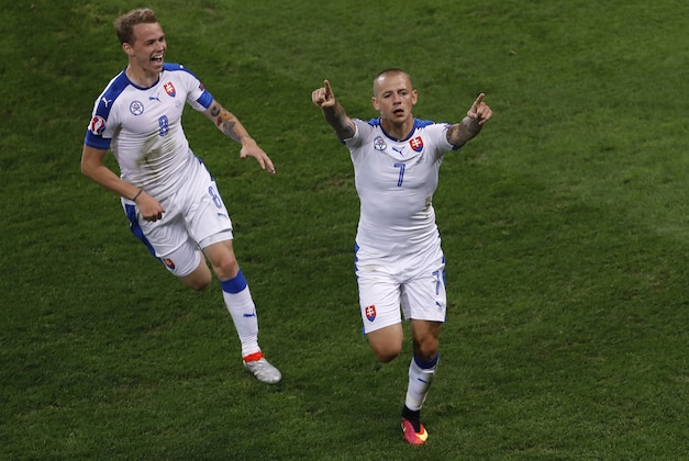 Slovakia's Vladimir Weiss, right, celebrates next to team mate Ondrej Duda after scoring a goal during the Euro 2016 Group B soccer match between Russia and Slovakia at the Pierre Mauroy stadium in Villeneuve d’Ascq, near Lille, France, Wednesday, June 15, 2016. (AP Photo/Darko Vojinovic)