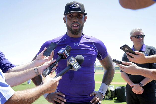 Colorado Rockies' Jose Reyes talks with reporters after an extended spring training workout, Thursday, May 19, 2016, at the Rockies' facility in Scottsdale, Ariz. Reyes was working out for the first time after being suspended under MLB domestic-violence policy. (AP Photo/Matt York)