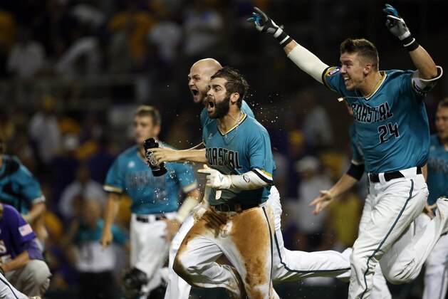 Coastal Carolina's Anthony Marks (29) reacts after sliding into home plate to score the winning run in the bottom of the ninth inning of an NCAA college baseball tournament super regional game against LSU in Baton Rouge, La., Sunday, June 12, 2016. Coastal Carolina won 4-3 to advance to the College World Series. (AP Photo/Gerald Herbert)
