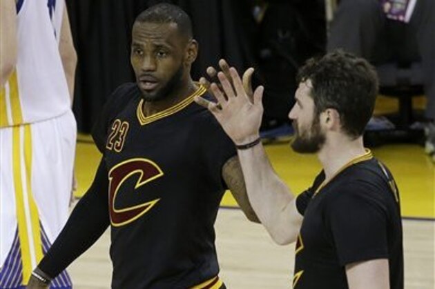 Cleveland Cavaliers forward LeBron James (23) and forward Kevin Love react during the second half of Game 5 of basketball's NBA Finals against the Golden State Warriors in Oakland, Calif., Monday, June 13, 2016. (AP Photo/Marcio Jose Sanchez)