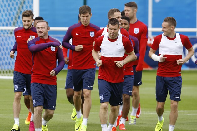 England’s captain Wayne Rooney, left, runs with players during a training session in Chantilly, France, Wednesday, June 15, 2016. England will face Wales in a Euro 2016 Group B soccer match in Lens on Thursday, June 16. (AP Photo/Kirsty Wigglesworth)