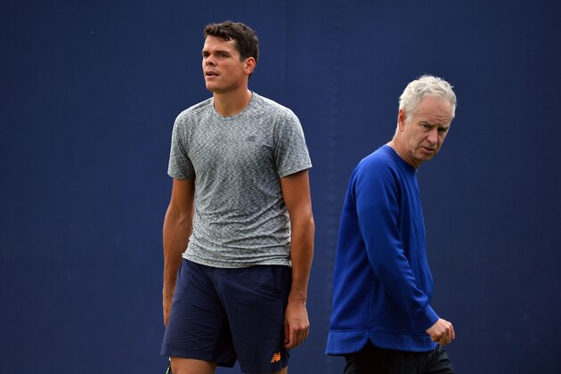 Canada's Milos Raonic is watched by Former US tennis player John McEnroe (R) during a practice session at the ATP tournament at Queen's tennis club, in London in west London on June 13, 2016. / AFP / GLYN KIRK        (Photo credit should read GLYN KIRK/AFP/Getty Images)