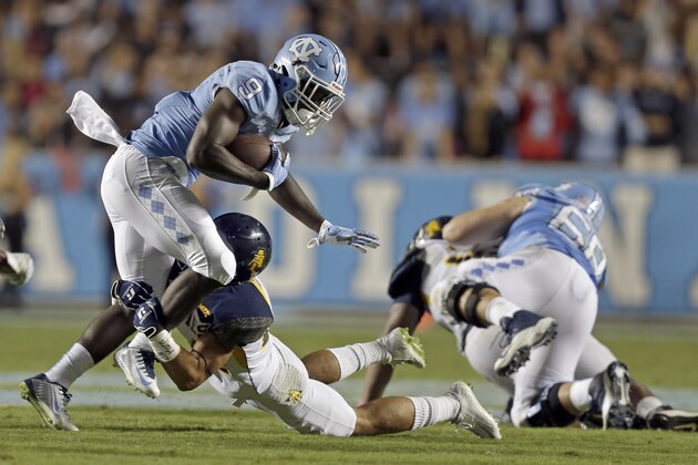 North Carolina's Ty'Son Williams (9) gains yardage as North Carolina A&T's Lorenz Suttles moves in for the tackle during the second half of an NCAA college football game in Chapel Hill, N.C., Saturday, Sept. 12, 2015. North Carolina won 53-14. (AP Photo/Gerry Broome)