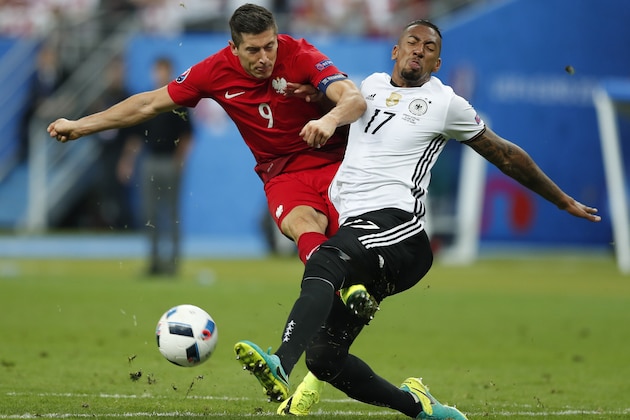 Poland's Robert Lewandowski, left, collides with Germany's Jerome Boateng during the Euro 2016 Group C soccer match between Germany and Poland at the Stade de France in Saint-Denis, north of Paris, France, Thursday, June 16, 2016. (AP Photo/Francois Mori)