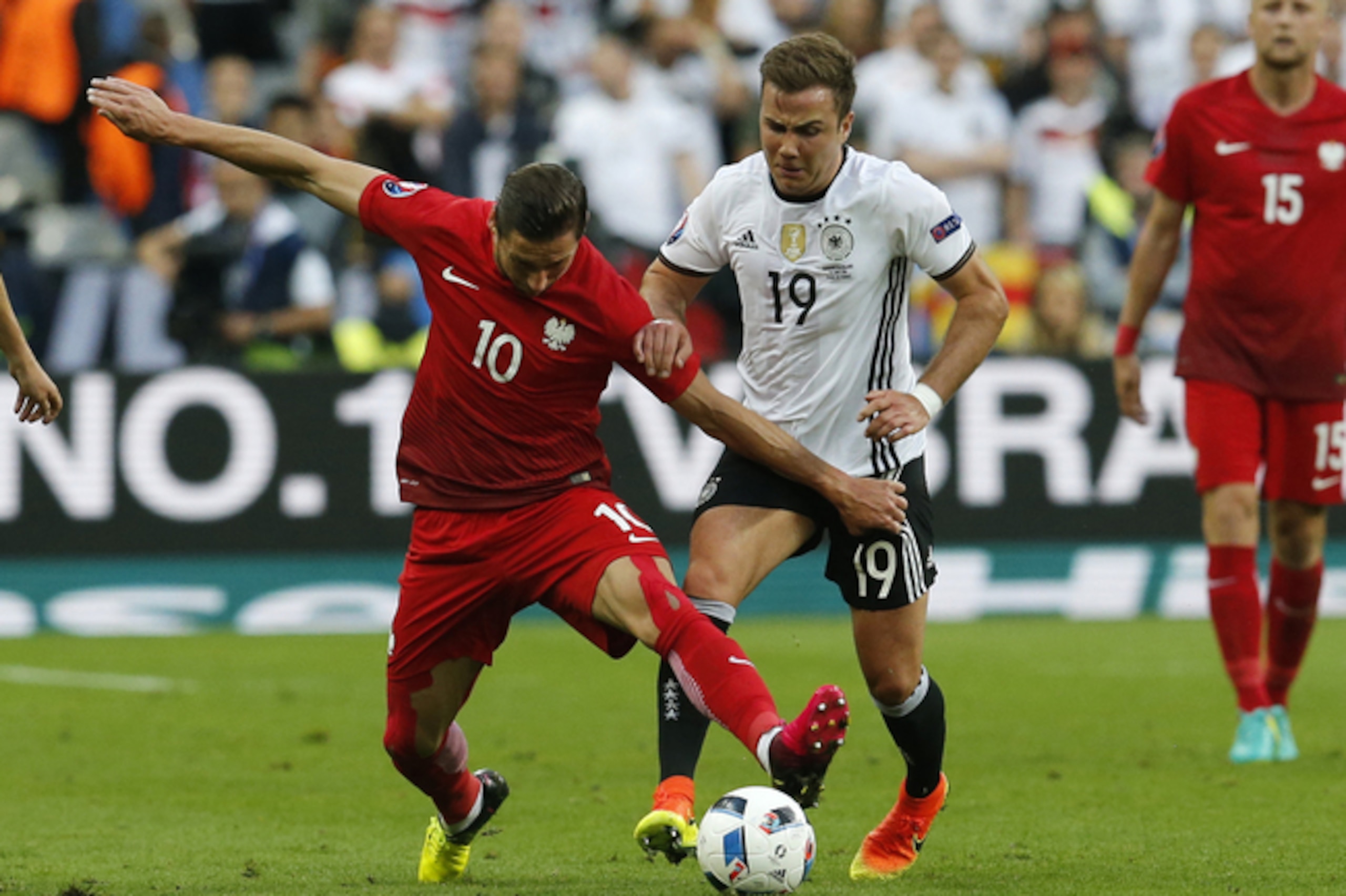Poland's Grzegorz Krychowiak, left, and Germany's Mario Goetze vie for the ball during the Euro 2016 Group C soccer match between Germany and Poland at the Stade de France in Saint-Denis, north of Paris, France, Thursday, June 16, 2016. (AP Photo/Michael Probst)