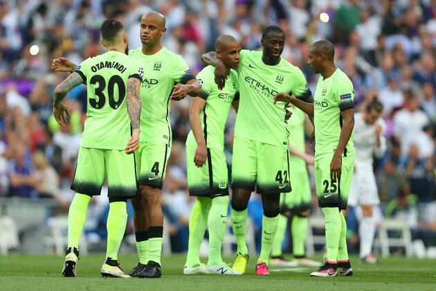 MADRID, SPAIN - MAY 04:  Vincent Kompany, Nicolas Otamendi, Fernando, Yaya Toure and Fernandinho of Manchester City hug before the UEFA Champions League Semi Final second leg match between Real Madrid and Manchester City FC at Estadio Santiago Bernabeu on May 4, 2016 in Madrid, Spain.  (Photo by Catherine Ivill - AMA/Getty Images)
