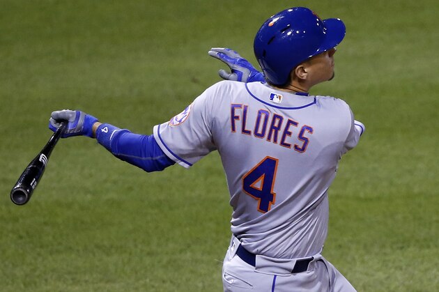 New York Mets' Wilmer Flores drives in a run with a single off Pittsburgh Pirates relief pitcher Cory Luebke during the 10th inning of a baseball game against the Pittsburgh Pirates in Pittsburgh, Wednesday, June 8, 2016. The Mets won 6-5. (AP Photo/Gene J. Puskar)