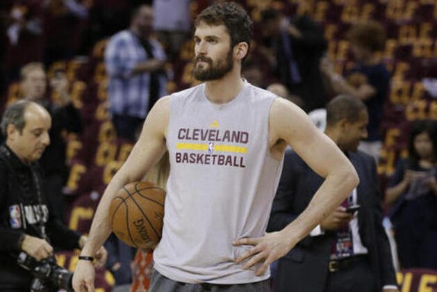 Cleveland Cavaliers forward Kevin Love pauses as players warm up for Game 4 of basketball's NBA Finals between the Cavaliers and the Golden State Warriors in Cleveland, Friday, June 10, 2016. (AP Photo/Tony Dejak)