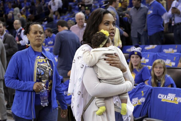 Ayesha Curry, right, wife of Golden State Warriors' Stephen Curry, holds daughter Ryan as they arrive at the NBA basketball game against the New Orleans Pelicans Tuesday, Oct. 27, 2015, in Oakland, Calif. (AP Photo/Ben Margot)