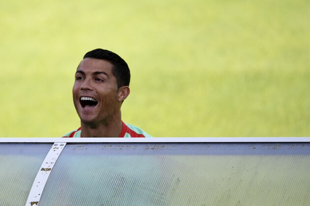 Portugal's forward Cristiano Ronaldo jokes with reporters prior to a training session at the team's base camp in Marcoussis on June 15, 2016, during the UEFA Euro 2016 football tornament. / AFP / FRANCISCO LEONG        (Photo credit should read FRANCISCO LEONG/AFP/Getty Images)