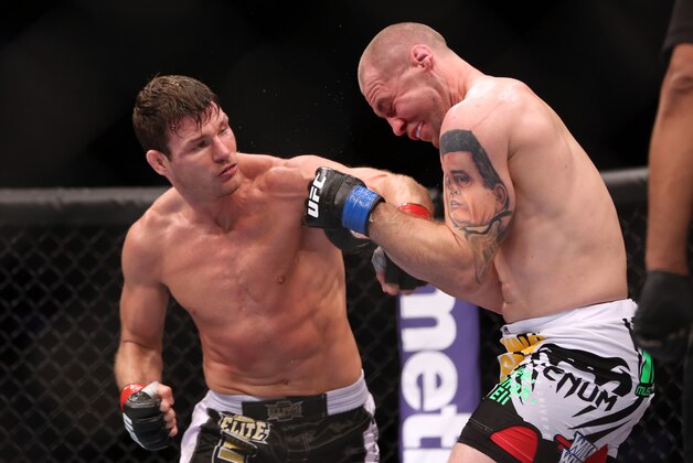 Michael Bisping, left, in action against Alan Belcher during their UFC 159 Mixed Martial Arts middleweight bout in Newark, NJ, Saturday, April 27,2013.  Bisping won via 3-round technical decision after an accidental eye poke. (AP Photo/Gregory Payan)