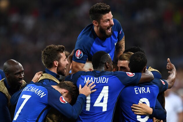 France's forward Olivier Giroud (top) and teammates celebrate during the Euro 2016 group A football match between France and Albania at the Velodrome stadium in Marseille on June 15, 2016.
France beat Albania 2-0.  / AFP / FRANCK FIFE        (Photo credit should read FRANCK FIFE/AFP/Getty Images)