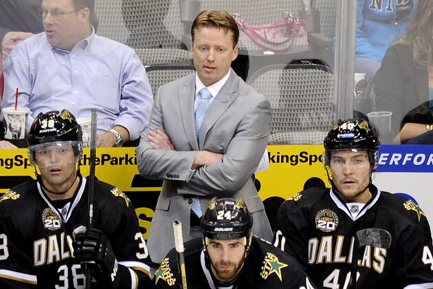 FILE- In this April 25, 2013, file photo, Dallas Stars head coach Glen Gulutzan watches play from behind the bench during the second period of an NHL hockey game against the Columbus Blue Jackets in Dallas. The Stars fired Gulutzan on Tuesday, May 14, 2013, after he failed to make the playoffs in two seasons at the helm. (AP Photo/Matt Strasen, File)