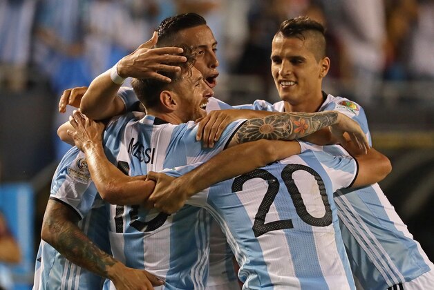 CHICAGO, IL - JUNE 10: Lionel Messi #10 of Argentina (center) is hugged by teammates including Ever Banega #19 , Nicolas Gaitan and Gabriel Mercado #4 after scoring a goal on a penalty kick against Panama during a match in the 2016 Copa America Centenario at Soldier Field on June 10, 2016 in Chicago, Illinois. Argentina defeated Panama 5-0. (Photo by Jonathan Daniel/Getty Images)
