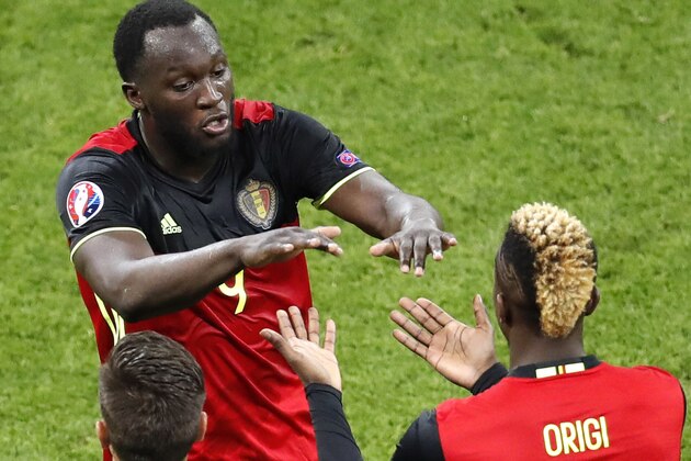 Belgium's Romelu Lukaku shakes hand with Origi as he leaves the pitch during the Euro 2016 Group E soccer match between Belgium and Italy at the Grand Stade in Decines-Charpieu, near Lyon, France, Monday, June 13, 2016. (AP Photo/Michael Sohn)