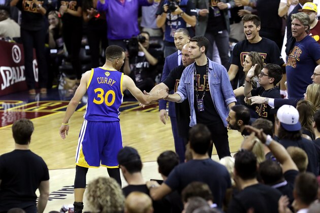 CLEVELAND, OH - JUNE 16:  Stephen Curry #30 of the Golden State Warriors shakes hands with Andrew Forbes, son of Cavaliers minority owner Nate Forbes, after throwing his mouthguard in the fourth quarter against the Cleveland Cavaliers in Game 6 of the 2016 NBA Finals at Quicken Loans Arena on June 16, 2016 in Cleveland, Ohio. NOTE TO USER: User expressly acknowledges and agrees that, by downloading and or using this photograph, User is consenting to the terms and conditions of the Getty Images License Agreement.  (Photo by Ronald Martinez/Getty Images)